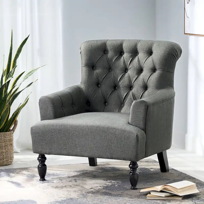 Fauteuil club capitonné Bernstein à dossier roulé par